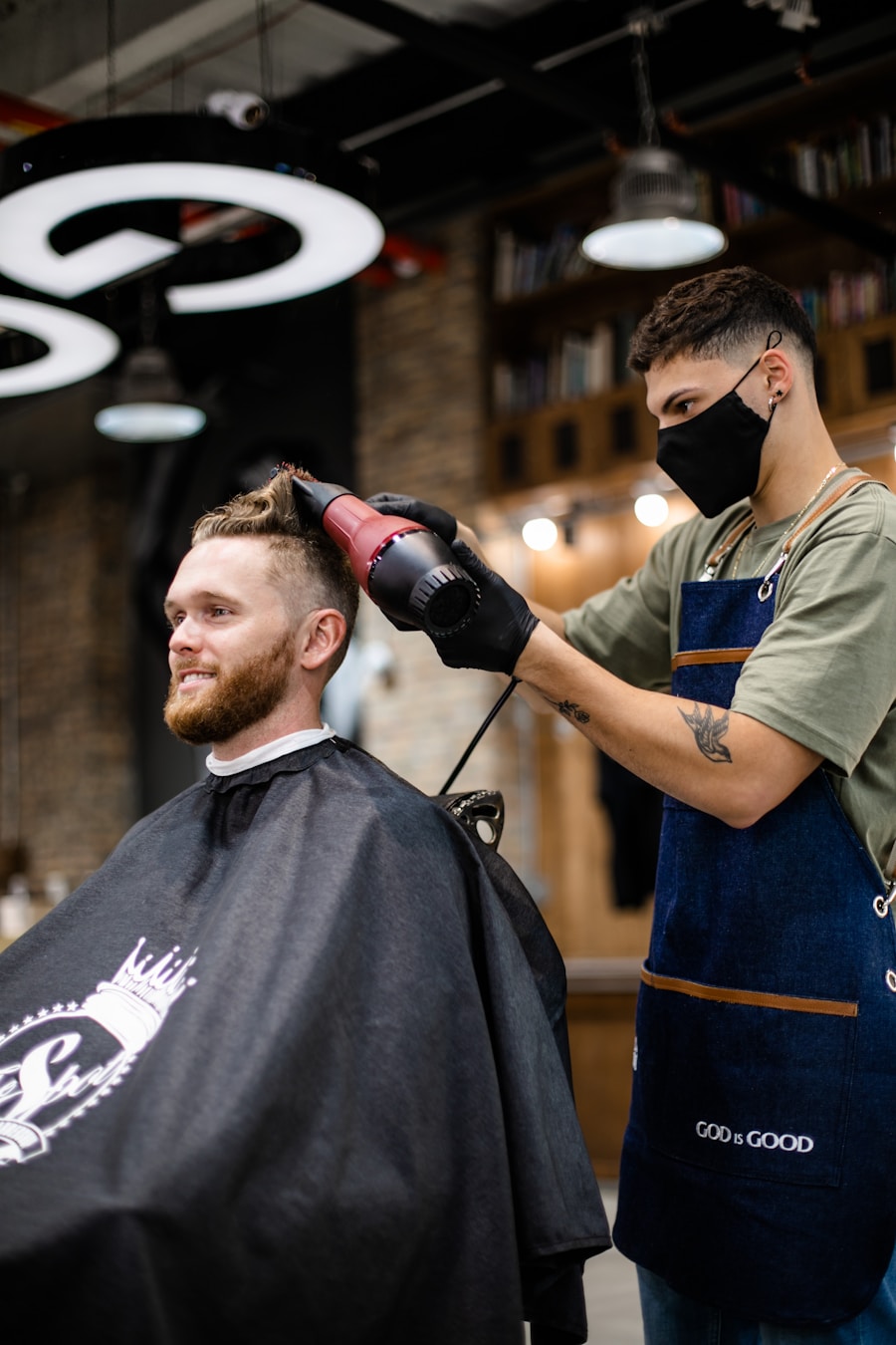 Barber drying a client’s hair in a modern shop
